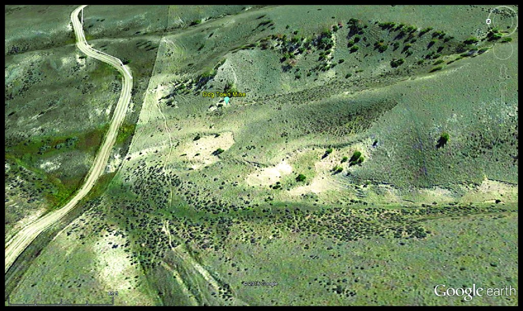 The Dog Town Mine site encompasses all of the light-colored exposures on the right side of the county road.