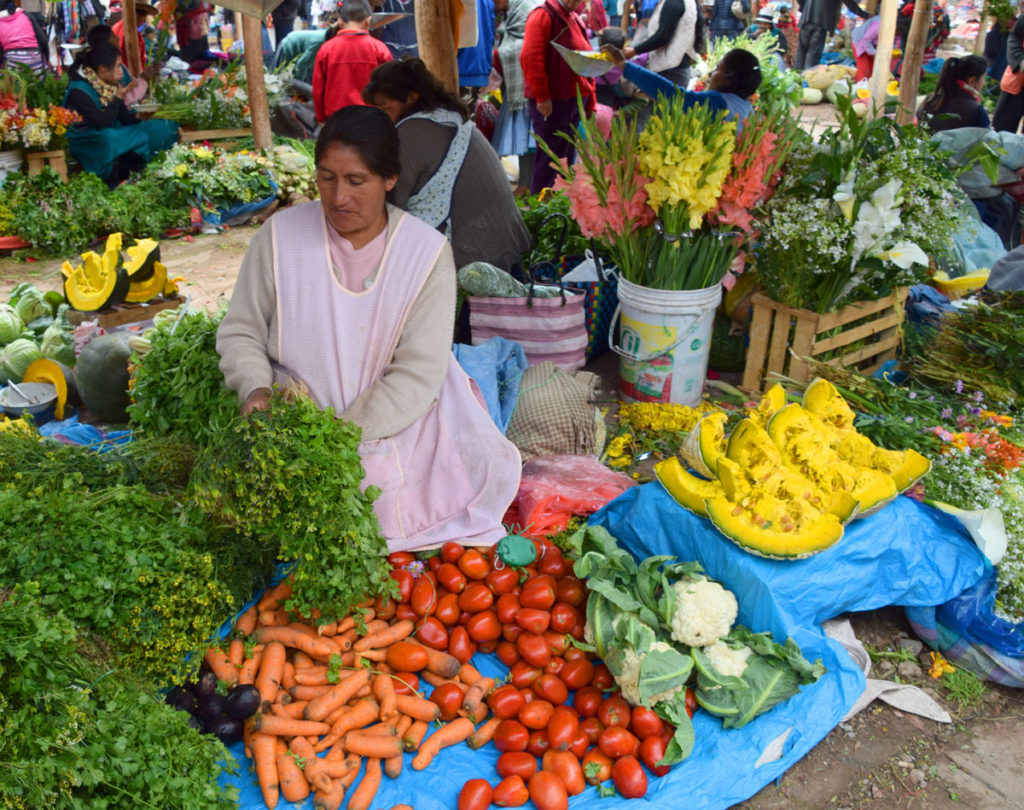 The Chinchero market, with a vendor selling produce and flowers. 